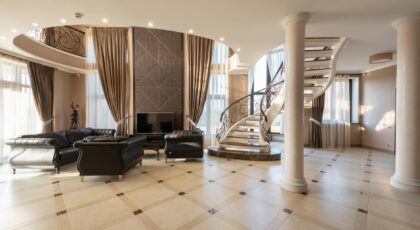 Elegant living room featuring a spiral staircase and classic furniture in a spacious modern home.