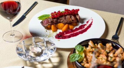 Delicious gourmet steak dinner with wine, served elegantly for fine dining.