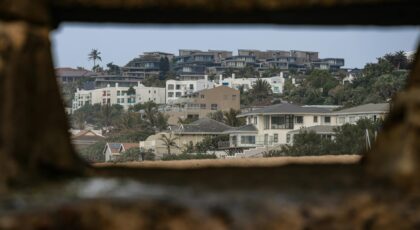 View of coastal homes framed by rustic stone, creating a unique perspective.