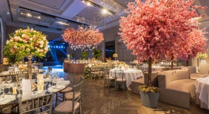 Elegant wedding reception with cherry blossoms and lavish decor in a luxurious setting.
