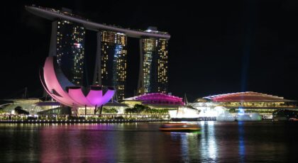 Stunning night view of Marina Bay Sands, Singapore, reflecting on water.