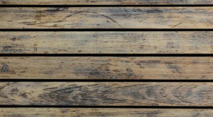 High-resolution image of a rustic wooden floor texture with natural grains and earthy tones.