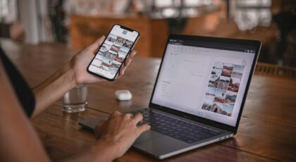 Woman edits social media content on phone and laptop at a cafe in Bali.