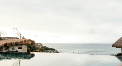 Serene infinity pool with panoramic sea view at a tropical resort.