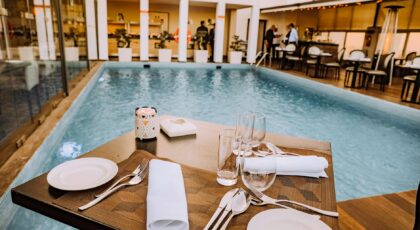 Relax by the poolside with this elegant dining setup at a luxurious resort.