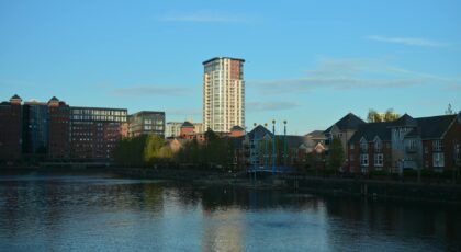 Beautiful urban landscape featuring modern architecture along a serene waterfront at sunset.