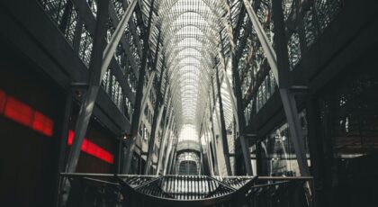 Impressive modern architecture featuring glass, steel, and light reflections in an urban setting.