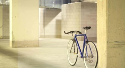 A modern blue bicycle parked indoors, highlighting urban minimalism.