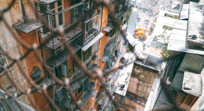 High angle view of an urban residential building with scaffolding and netting.