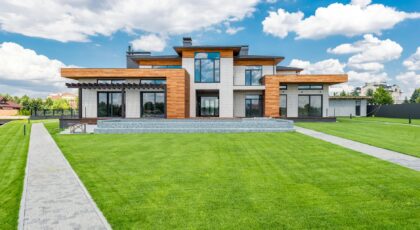 Stunning modern house exterior showcasing spacious lawn and contemporary architecture.