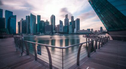 Breathtaking view of Singapore's modern skyline reflecting on the water at twilight.