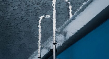Creative water reflection with metal pipe in a swimming pool.
