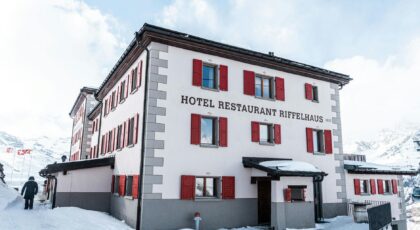 Scenic view of Hotel Riffelhaus 1853 nestled in the snowy Swiss Alps.