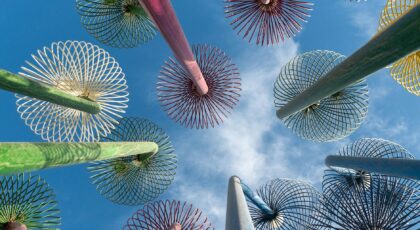 Artistic view of colorful steel supertrees set against a vibrant blue sky, perfect for abstract themes.