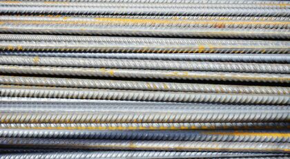 Close-up of stacked rusty steel reinforcing bars used in construction.