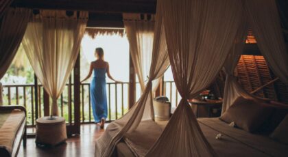 Peaceful bedroom in tropical villa with balcony view, perfect for relaxation.