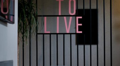 Contemporary cafe interior with chairs and decor, featuring motivational text on wall.