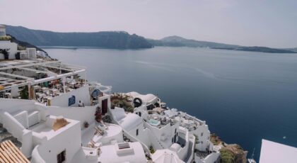 Stunning Santorini view capturing the iconic whitewashed buildings against a blue sea and sky.