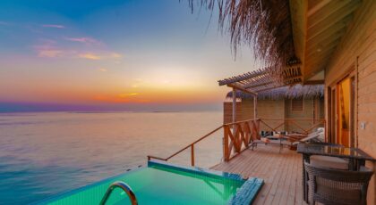 Peaceful overwater villa with private pool at sunset in the Maldives.