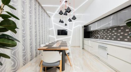 Sleek modern dining room featuring contemporary lighting, minimalistic design, and spacious layout.