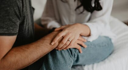 A tender moment of a couple holding hands, symbolizing love and connection.