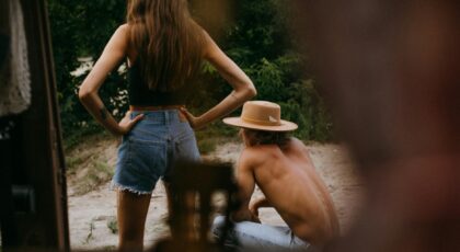 Two people enjoy a relaxing summer day outdoors, captured in a candid moment.