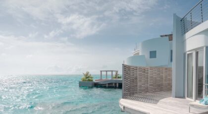 Stunning oceanfront villa with an infinity pool and clear blue skies.