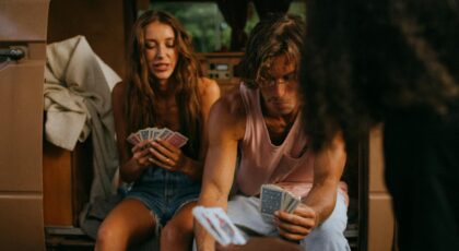 A group of friends playing cards in a cozy vintage camper. Perfect for travel and adventure themes.