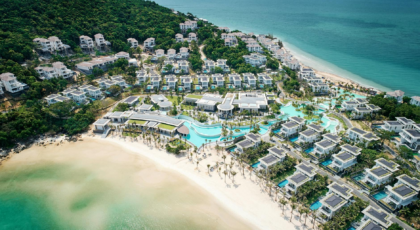 Stunning aerial view of a luxurious beach resort with villas and pools on tropical coastline in Vietnam.