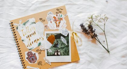 A dreamy scrapbook layout with floral decorations and motivational cutouts.