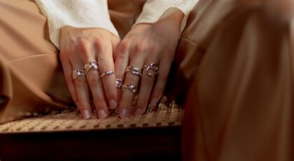 Close-up of a woman's hands adorned with elegant silver rings, highlighting modern fashion.
