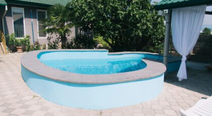 Cozy backyard with modern pool and lush greenery, ideal for relaxation.