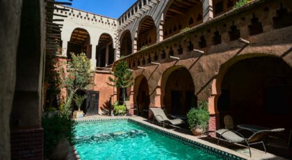 Stunning Mediterranean villa courtyard with an inviting shimmering pool and elegant arches.