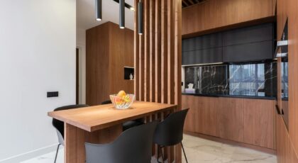 A sleek and stylish kitchen interior featuring wooden cabinetry and contemporary design elements.