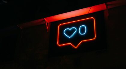Bright neon heart icon with zero likes, symbolizing social media engagement.