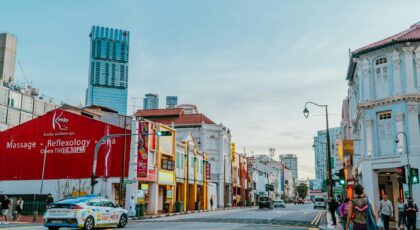 Street scene in Singapore showcasing Kenko Wellness Spa and vibrant architecture.