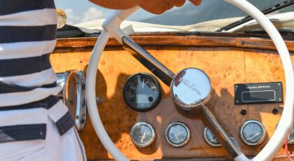 Vintage steering wheel on a motorboat at Lake Como. Luxurious travel in Italy.