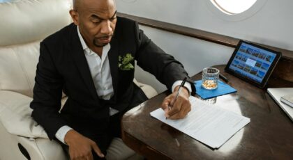 Businessman reviewing documents in a luxurious private jet cabin, displaying elite travel lifestyle.