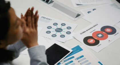 Businesswoman reviewing charts and documents during a professional meeting in an office setting.