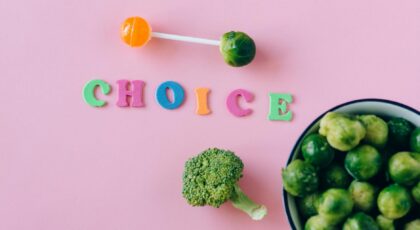Colorful depiction of healthy and sweet food choices on pink backdrop.
