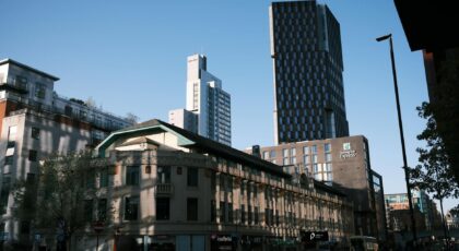 A vibrant urban scene featuring modern high-rise buildings under a clear blue sky.