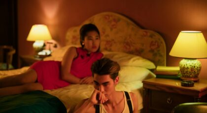 A couple in a warmly lit bedroom, reflecting on their relationship, creating a serene ambiance.