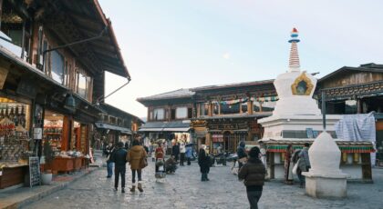 A vibrant day in Shangri-La Old Town with shops and cultural architecture.
