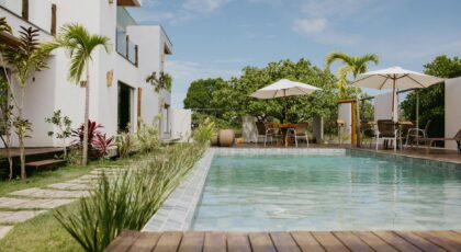 Beautiful modern villa with a pool surrounded by lush greenery in Bahia, Brazil.