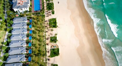 Stunning aerial beach resort view featuring turquoise waters and sandy shores, perfect for tropical getaways.