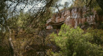 Explore the hidden cave amidst Le Pradet's lush greenery and rugged mountainside.