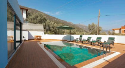 Relax at a luxurious villa with mountain-view pool and sun loungers.